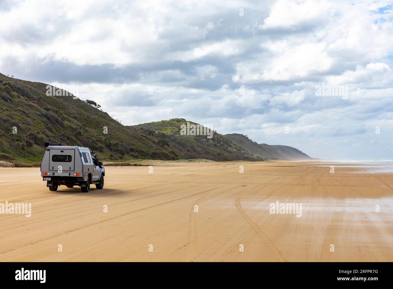 Fraser Island K'gari, 75 mile beach with 4WD 4x4 vehicle driving on the licensed sand road beside the ocean,Queensland,Australia Stock Photo