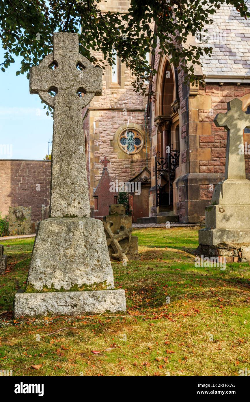 FORT WILLIAM, GREAT BRITAIN - SEPTEMBER 12, 2014: This is a headstone with a Celtic cross in the cemetery at the Church of St. Andrew. Stock Photo