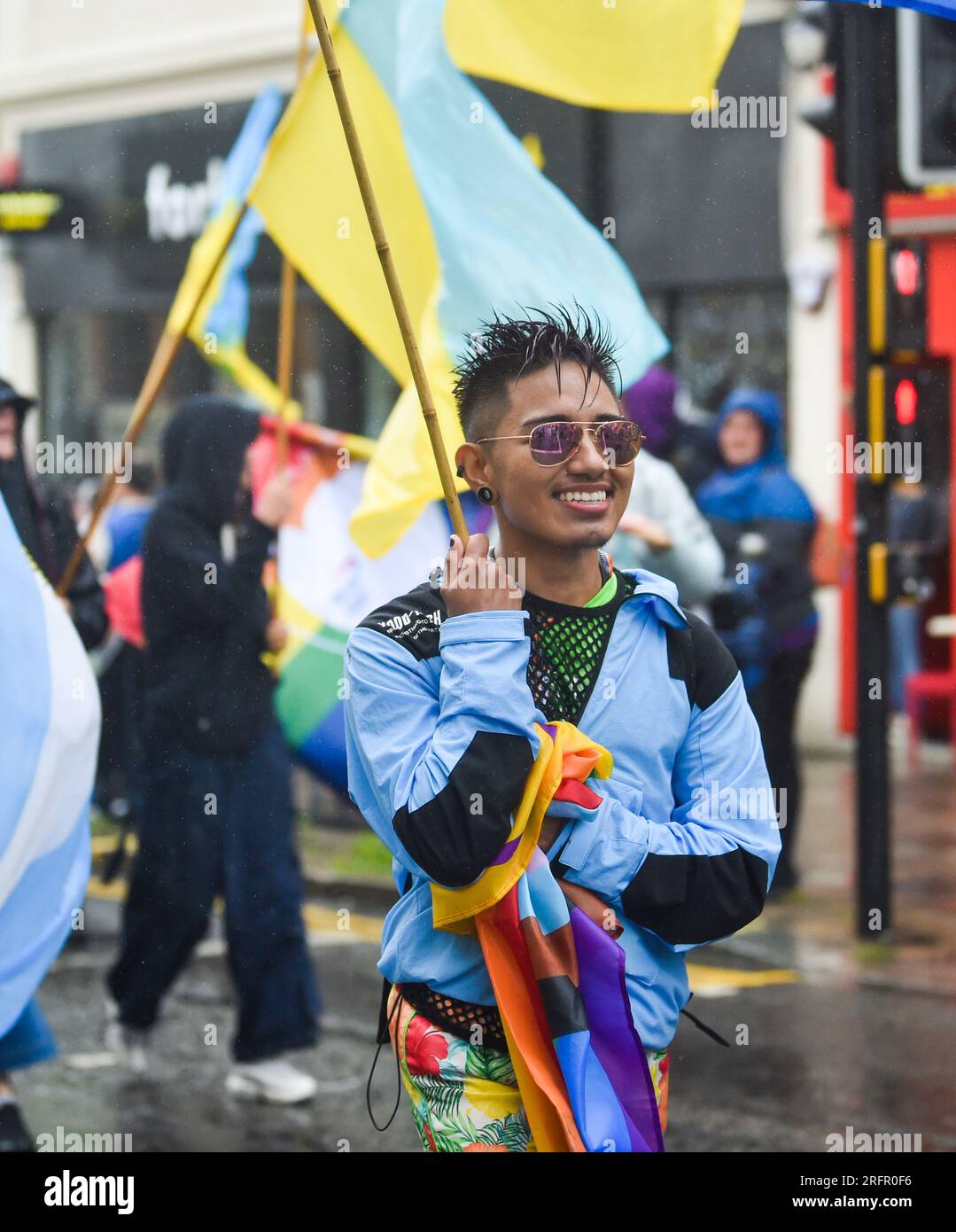 Brighton UK 5th August 2023 - Thousands take part in the Brighton & Hove Pride Parade despite the dreadful weather  caused by Storm Antoni which is battering arts of Britain today with strong winds and rain  : Credit Simon Dack / Alamy Live News Stock Photo