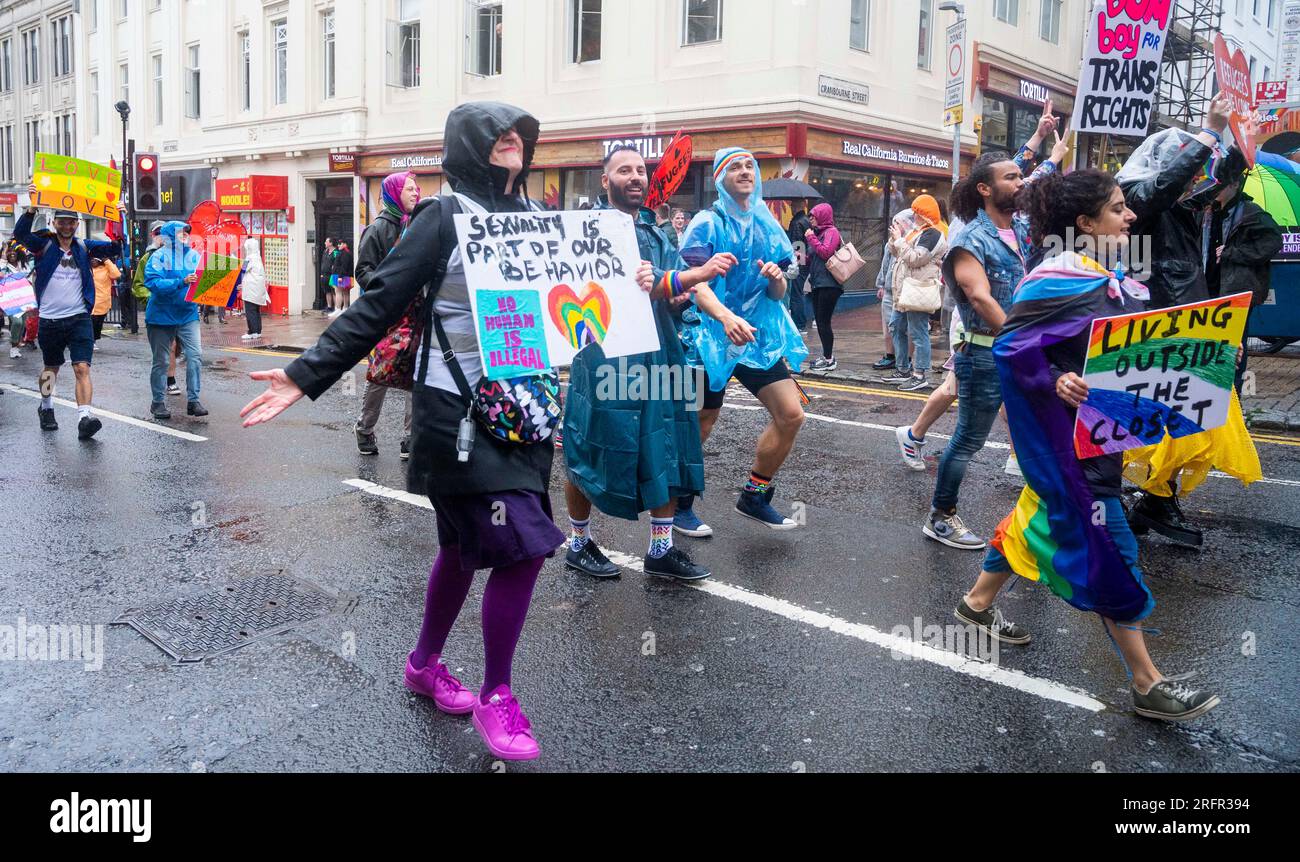 Brighton UK 5th August 2023 - Thousands take part in the Brighton & Hove Pride Parade despite the dreadful weather  caused by Storm Antoni which is battering arts of Britain today with strong winds and rain  : Credit Simon Dack / Alamy Live News Stock Photo