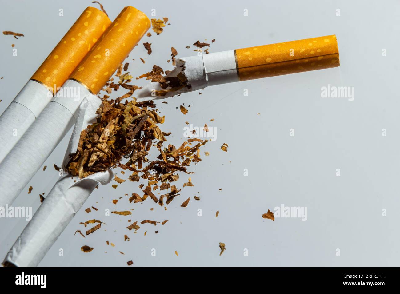 Broken cigarette fly in air on a light background. Conception of combating  smoking Stock Photo