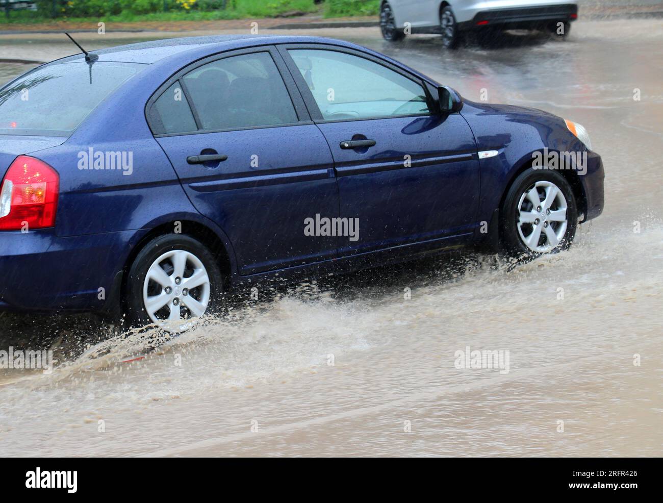 Car wheels in water during heavy rain Stock Photo Alamy