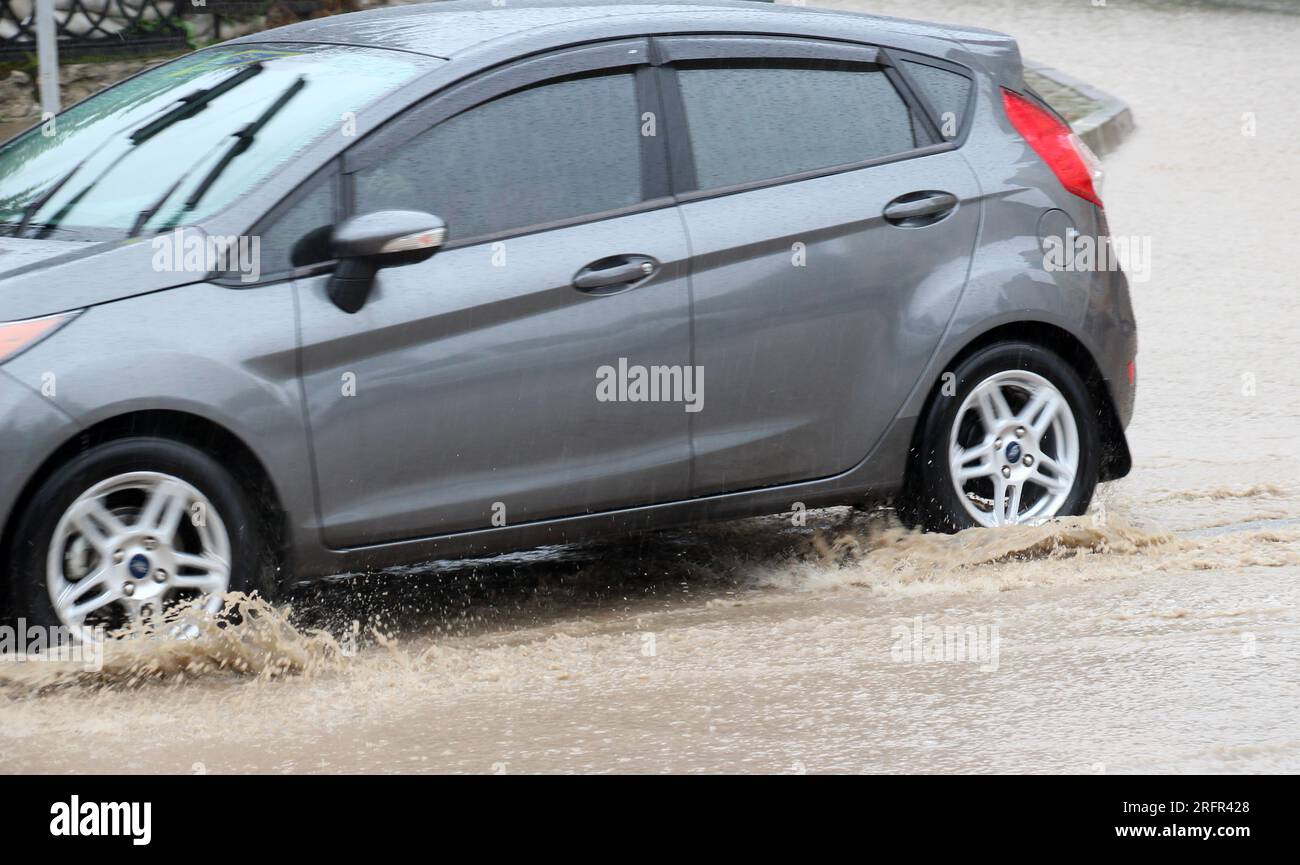 Car wheels in water during heavy rain Stock Photo Alamy