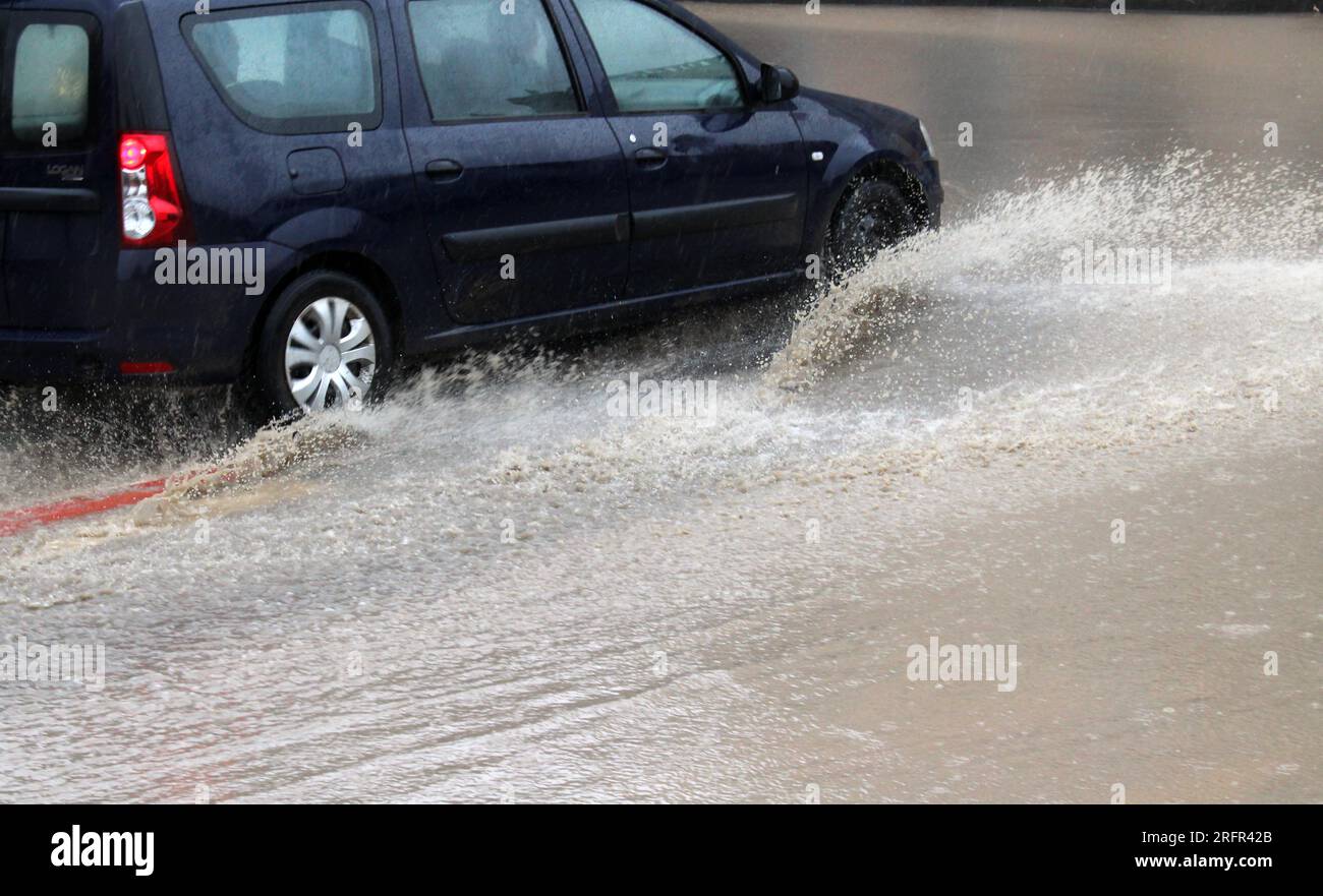 Car wheels in water during heavy rain Stock Photo Alamy