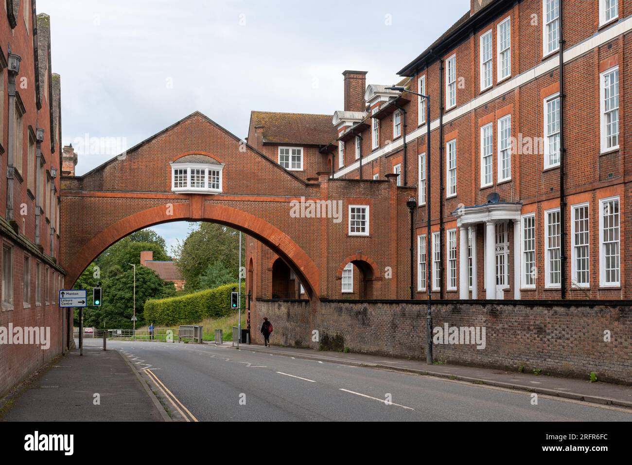 Marlborough College buildings and arch across road, pubic school in the Wiltshire town, England, UK Stock Photo