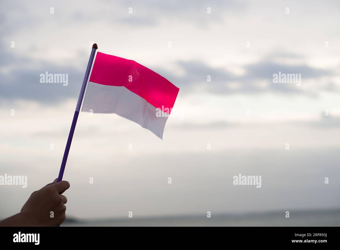 Hand holding a Indonesian flag. Independence day. Indonesian flag Stock Photo