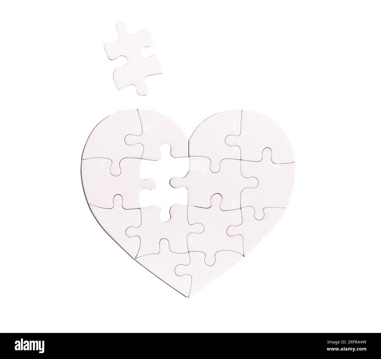 Heart shaped puzzle with missing lacking piece isolated on white background. Love problems concept. Stock Photo