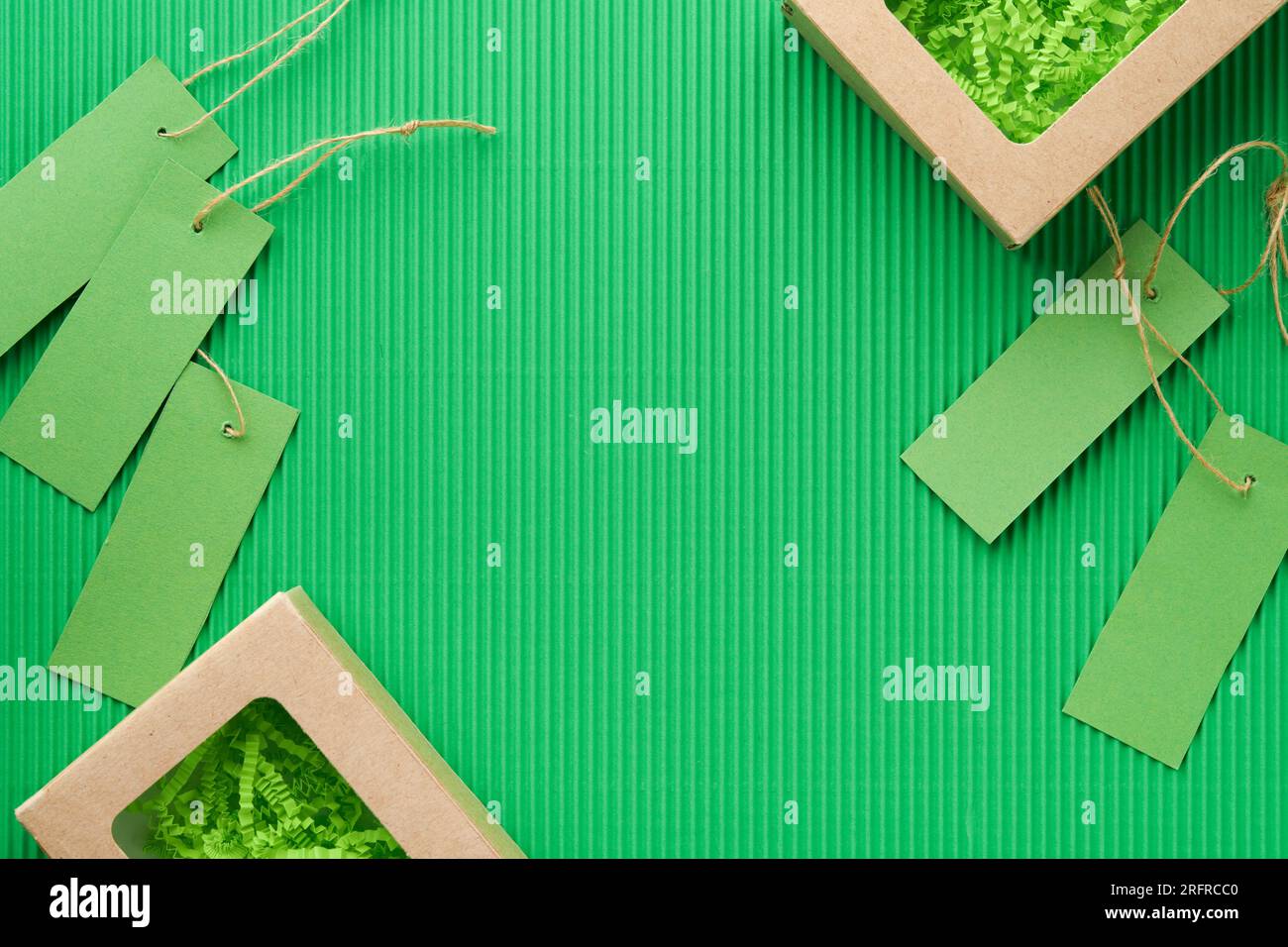 Green Friday backgrounds mock up. Sale Tag on green background. Paper shopping boxes and green tag. Environmentally friendly shopping idea, useful thi Stock Photo