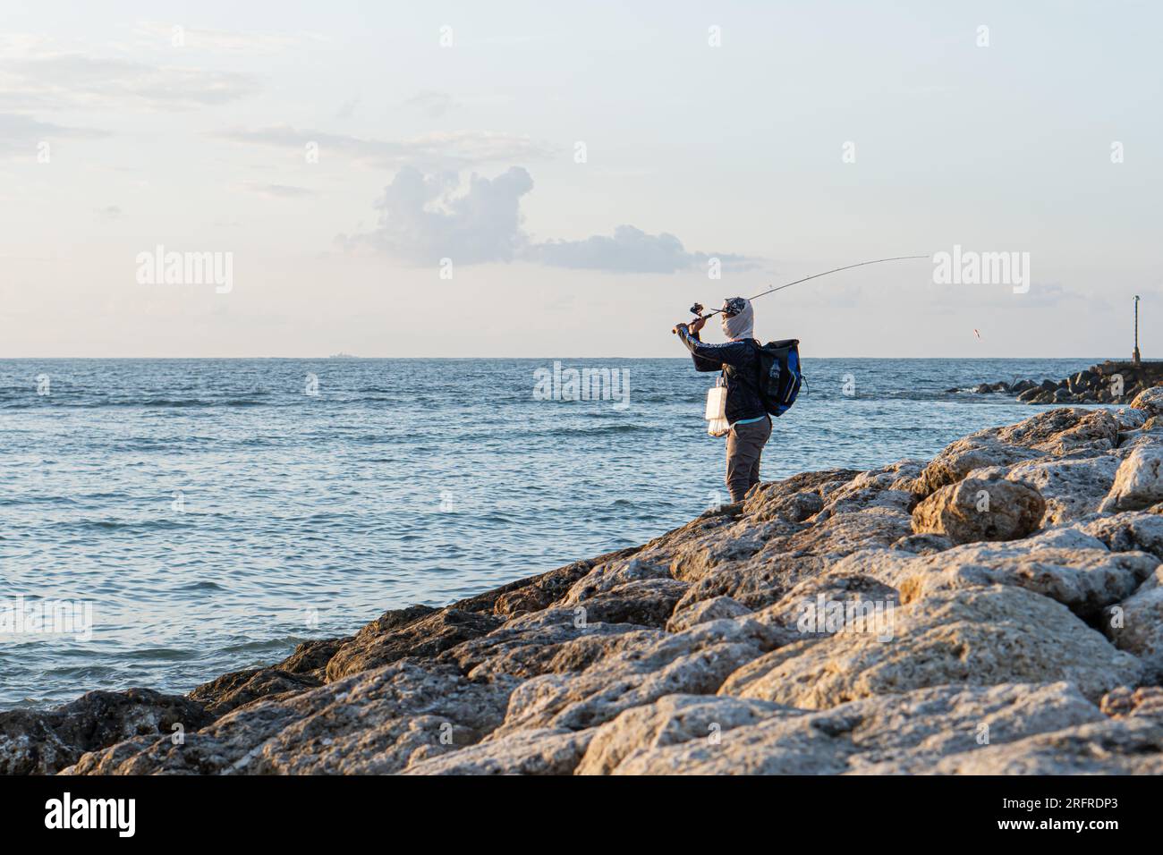 Fishing Rod Is Left On The Rock At The Marina Beach Semarang. Indonesia.  Stock Photo, Picture and Royalty Free Image. Image 197299928.