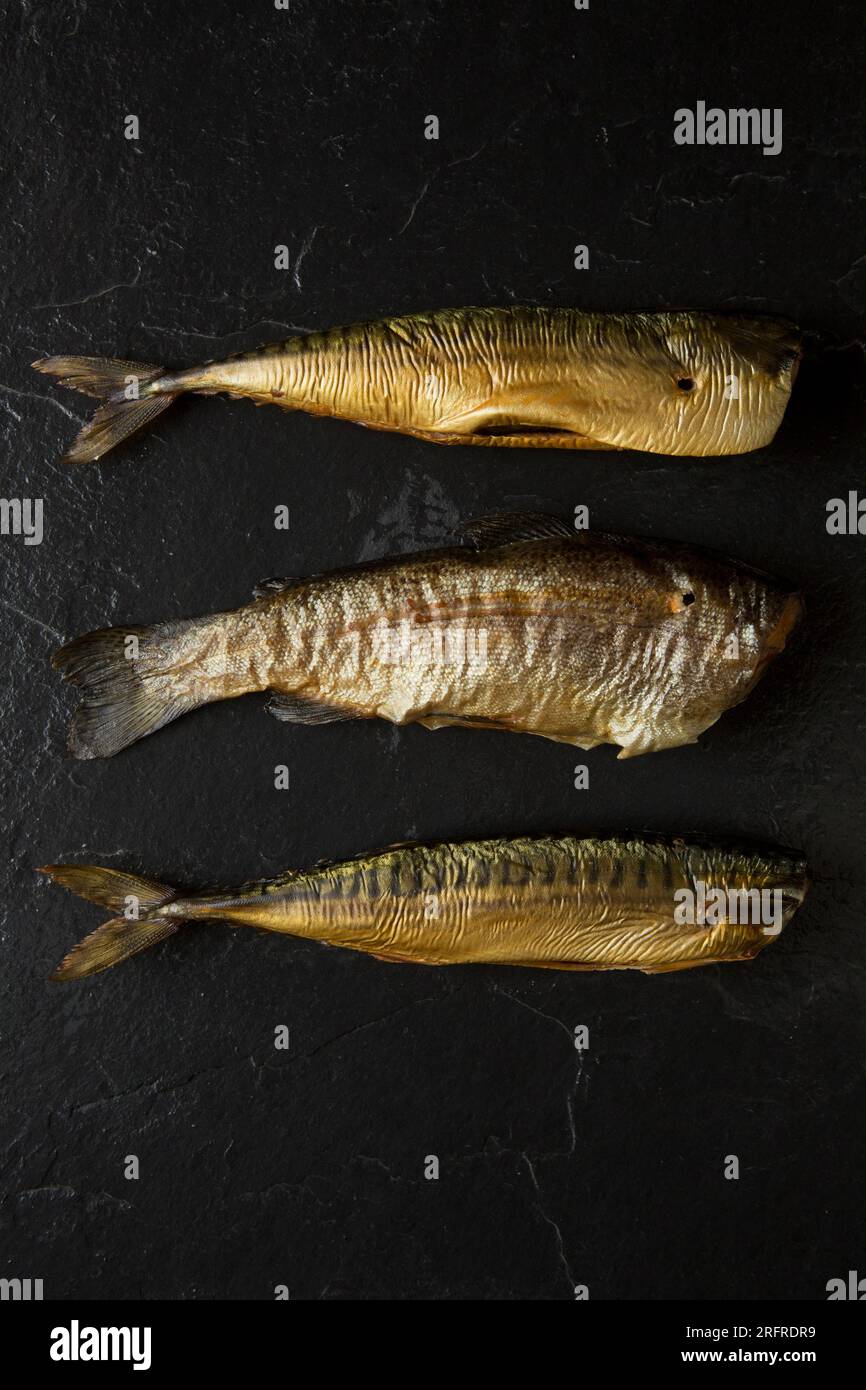 Hot smoked mackerel, Scomber scombrus, and hot smoked rainbow trout, Oncorhynchus mykiss. England UK GB Stock Photo