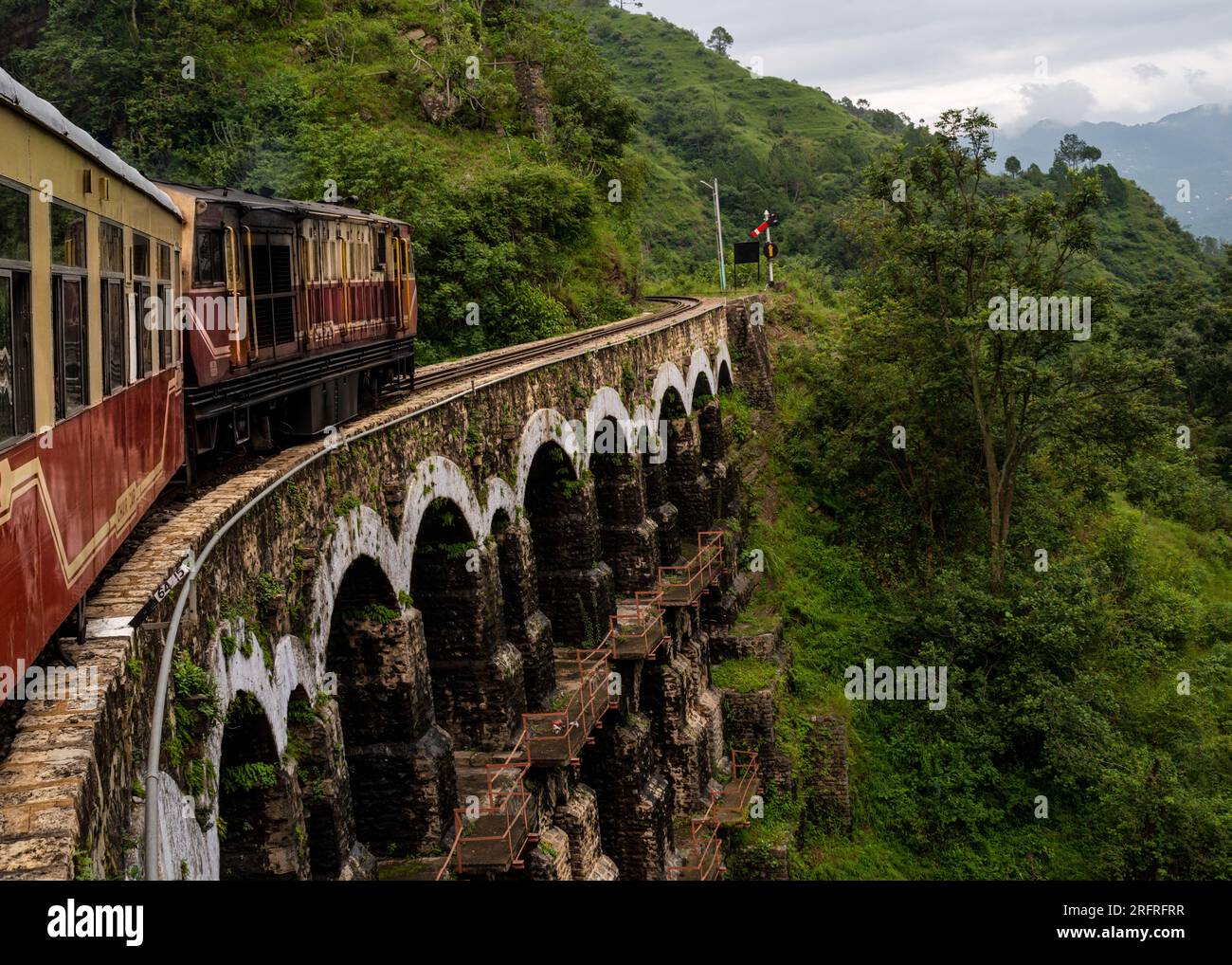 Himalayan Queen Toy train KalkaShimla route, moving on railway to the hill, among green natural