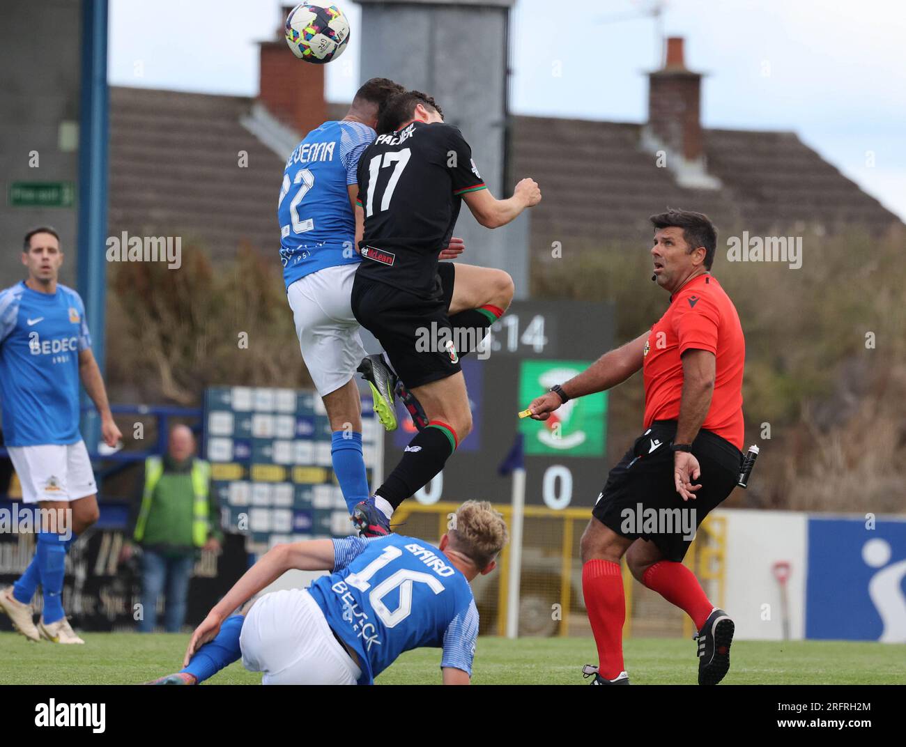 Mourneview Park, Lurgan, County Armagh, Northern Ireland, UK. 05 Aug 2023. Sports Direct Premiership – Glenavon v Glentoran, Premiership season opener. Action from today's game at Mourneview Park (Glenavon in blue). Tiarnan Mulvenna (22) and Cameron Palmer (17) battle for possession watched by referee Andrew Davey. Credit: CAZIMB/Alamy Live News. Stock Photo