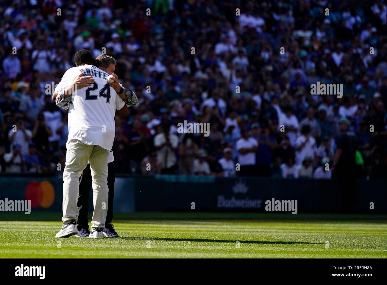 Former Seattle Mariners players Edgar Martinez, facing, greets Ken Griffey  Jr. (24) as they prepare to throw out ceremonial first pitches during the  MLB All-Star baseball game in Seattle, Tuesday, July 11