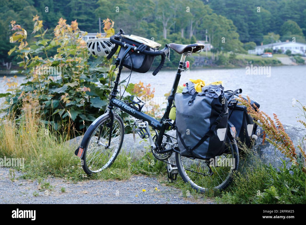 Bike Friday folding bicycle parked on side of shore, loaded with panier on an overnight expedition Stock Photo