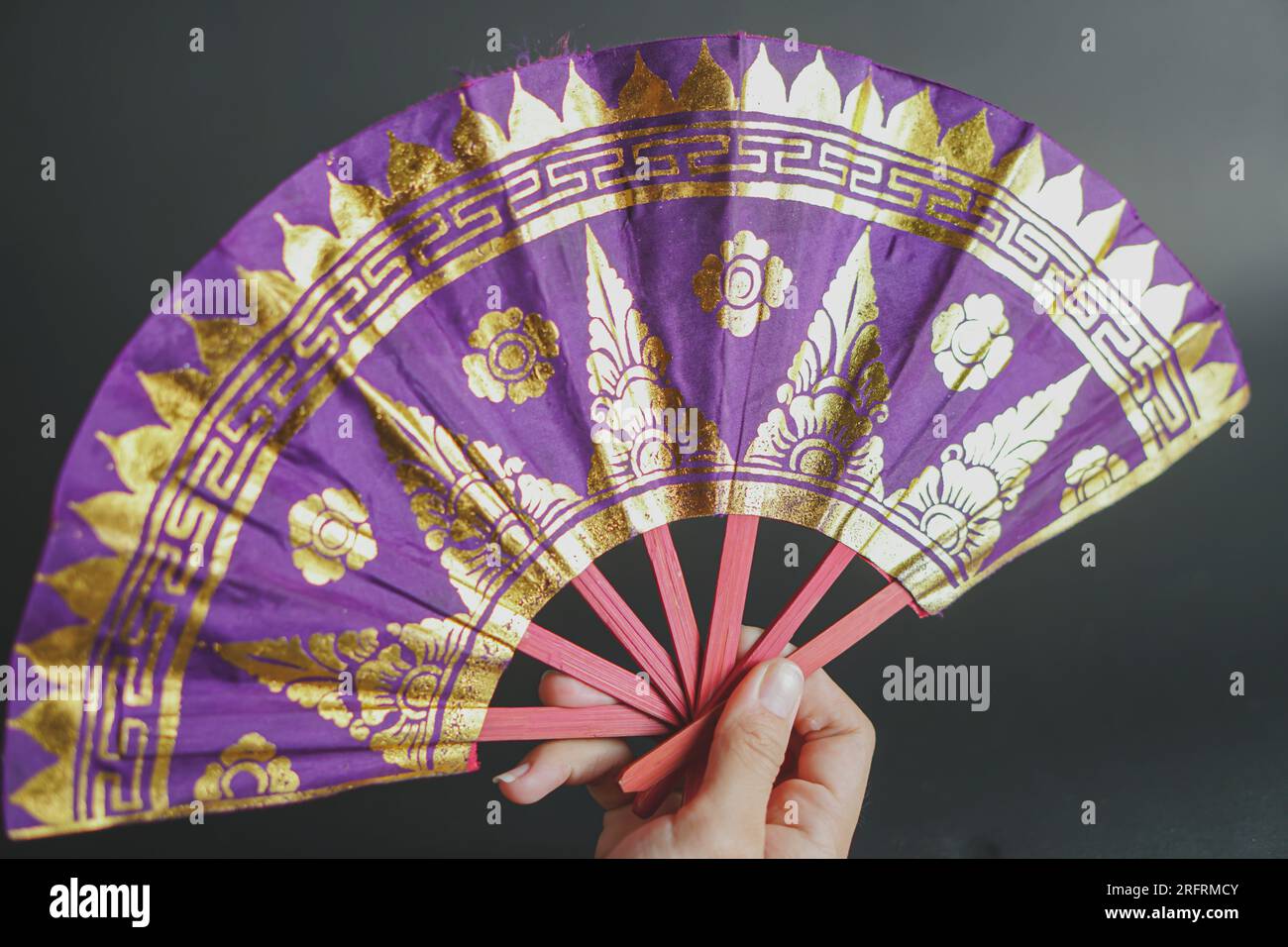 texture of Traditional Balinese hand fan patterned prada isolated on dark background Stock Photo