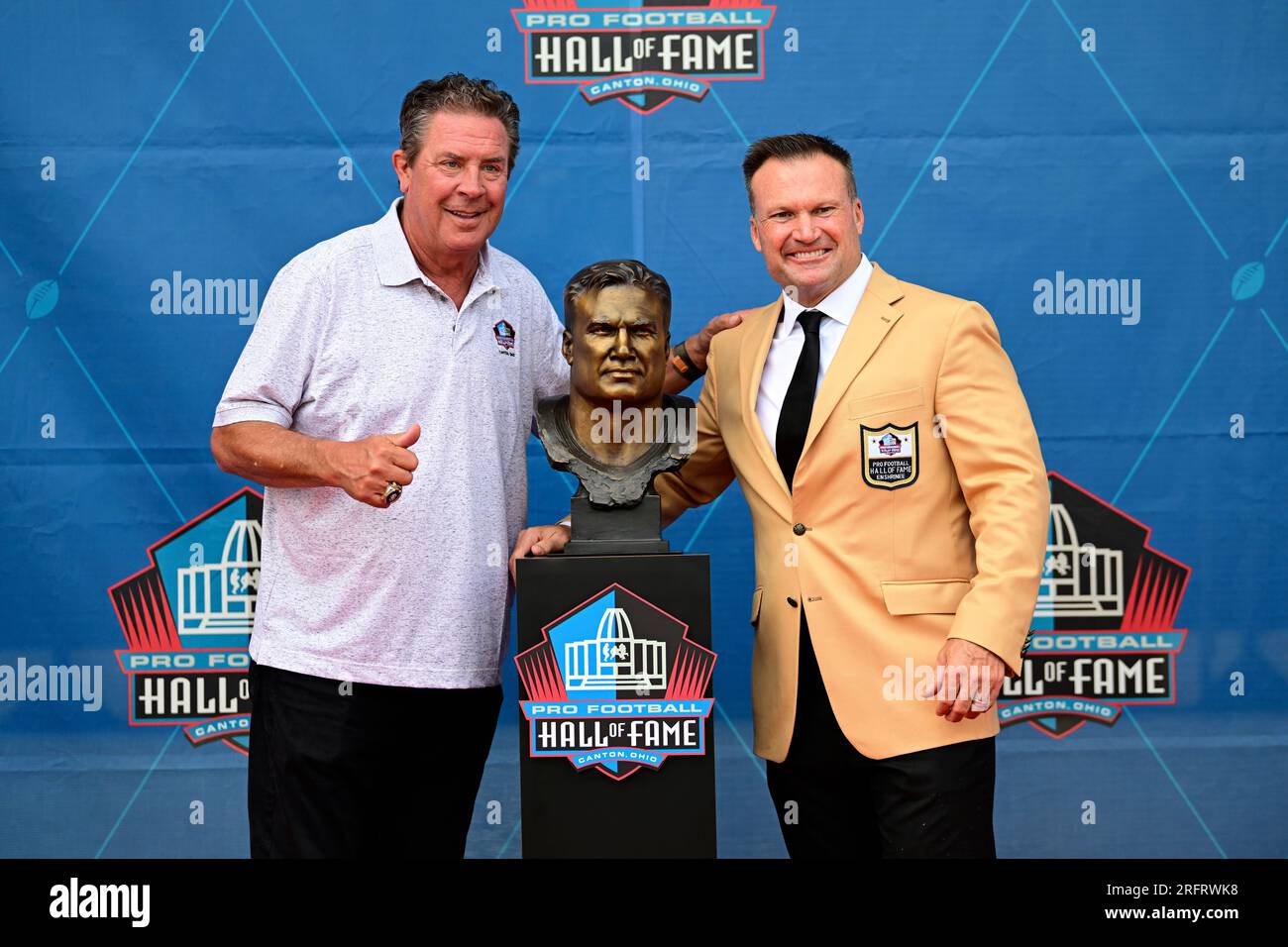 Former NFL player Zach Thomas, right, poses with Dan Marino during