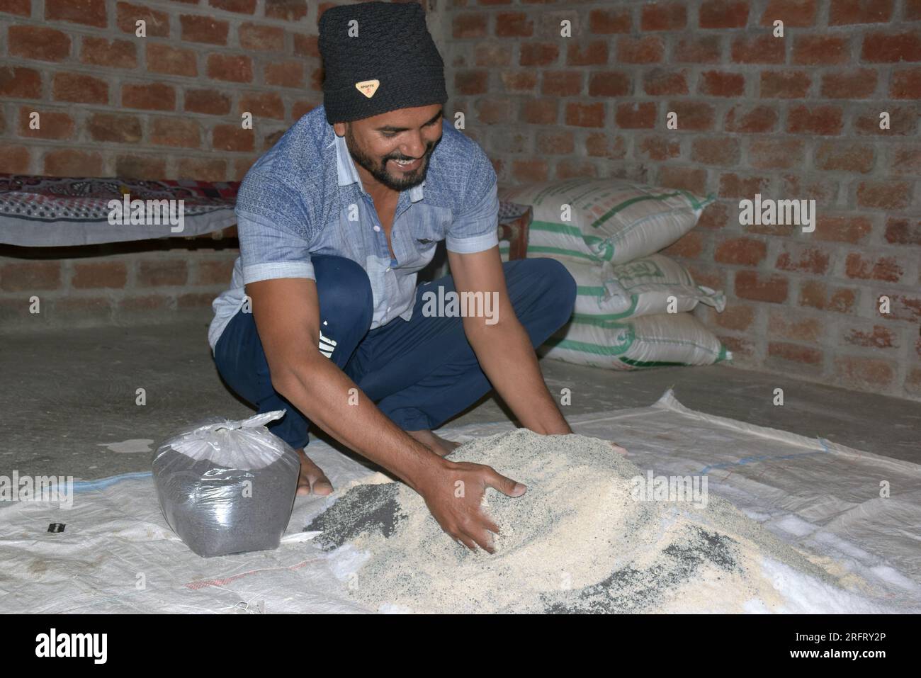 09-12-2021 Indore, Madhya Pradesh, India. Indian farmer mixing different fertilizer elements in manure, at home. selective focus Stock Photo