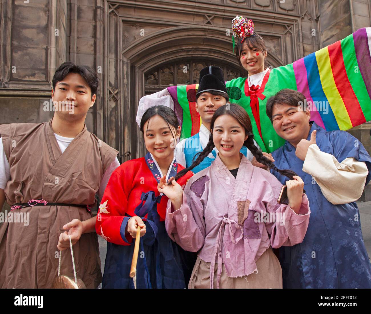 Edinburgh Festival Fringe, Scotland, UK. 5 August 2023. Slow start for audiences on the Royal Mile for audiences  on this first Saturday but crowds began to filter through mid  afternoon, when a heavy down pour for around half an hour  occurred. Street Performers kept most of the people watching  their show. Pictured: South Korean cast from You Want A GameCredit: Archwhite/alamy live news. Stock Photo