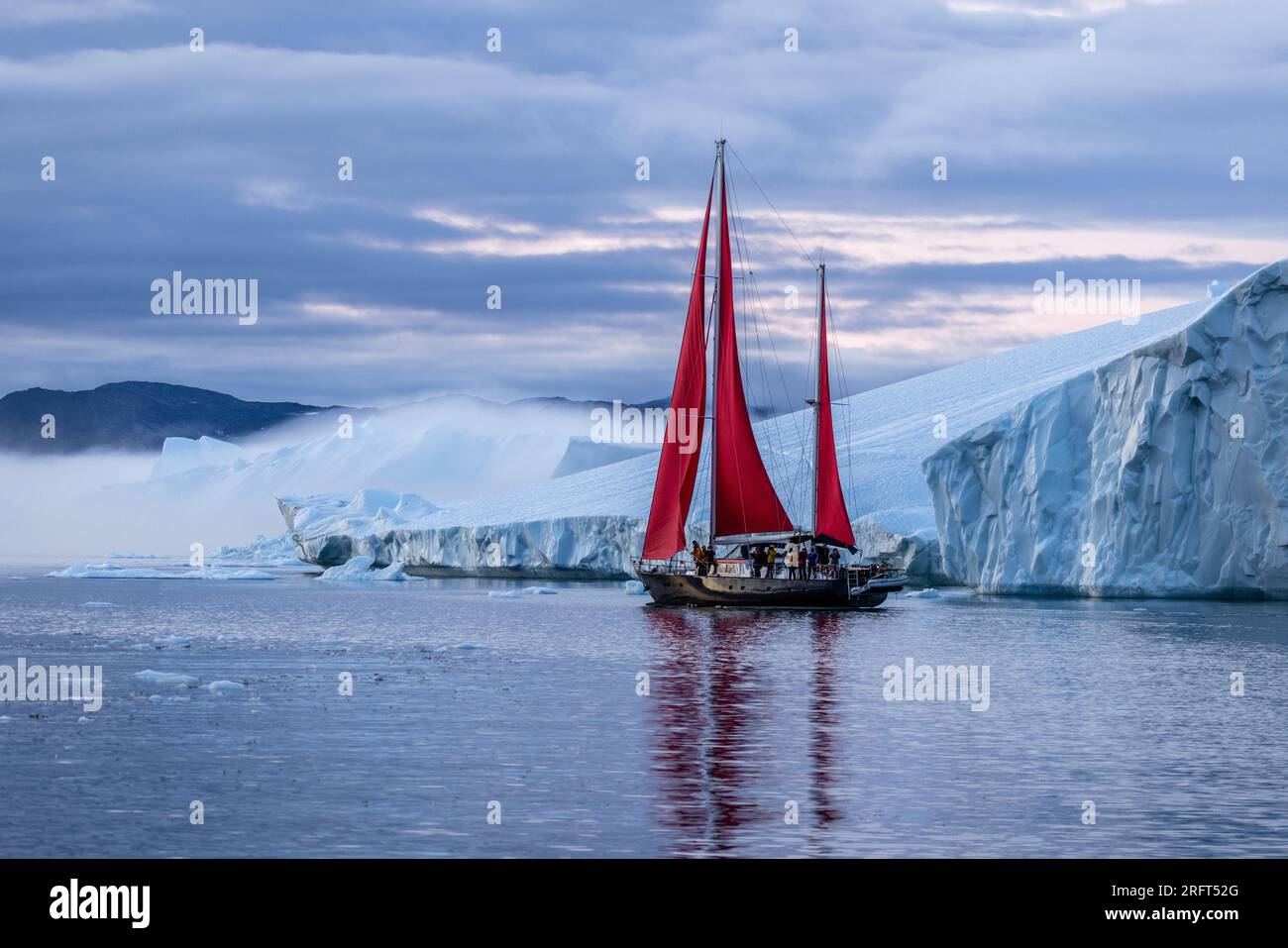 Red sails along Ilulissat Ice Fjord north of the Arctic Circle, Disko Bay, Greenland Stock Photo