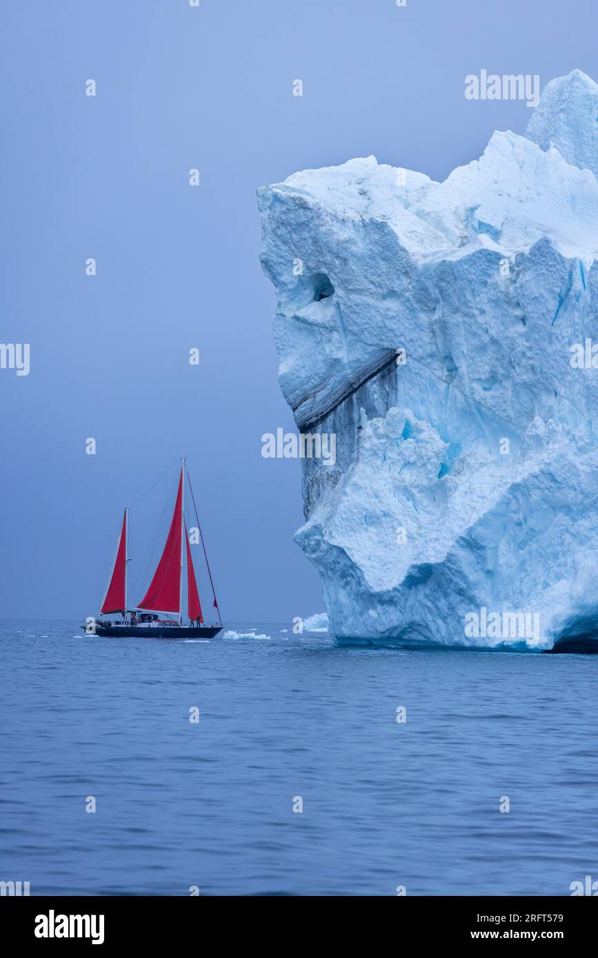 Sailing into the monster iceberg 'Beauty and the Beast' in Disko Bay near Ilulissat Icefjord, Greenland Stock Photo
