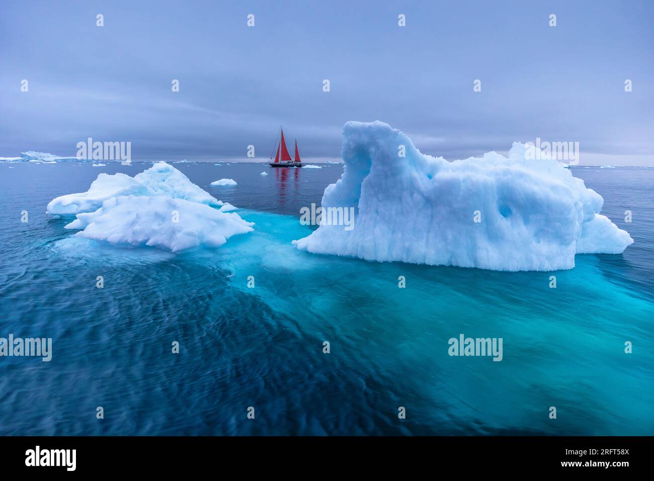 Red sails along Ilulissat Ice Fjord north of the Arctic Circle, Disko Bay, Greenland Stock Photo