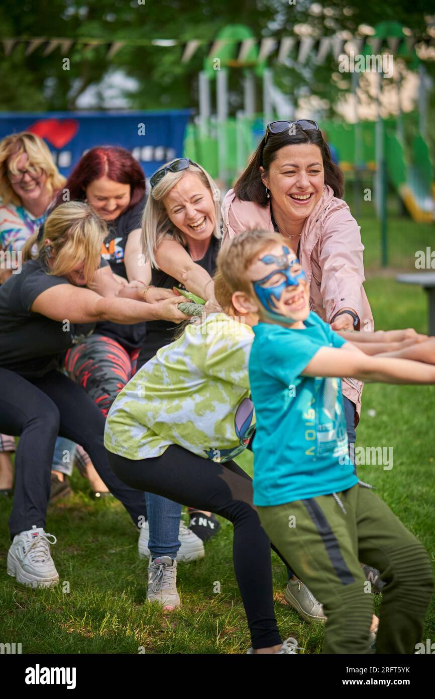 Group of people pulling a rope during a kindergarten festival in Poznan ...