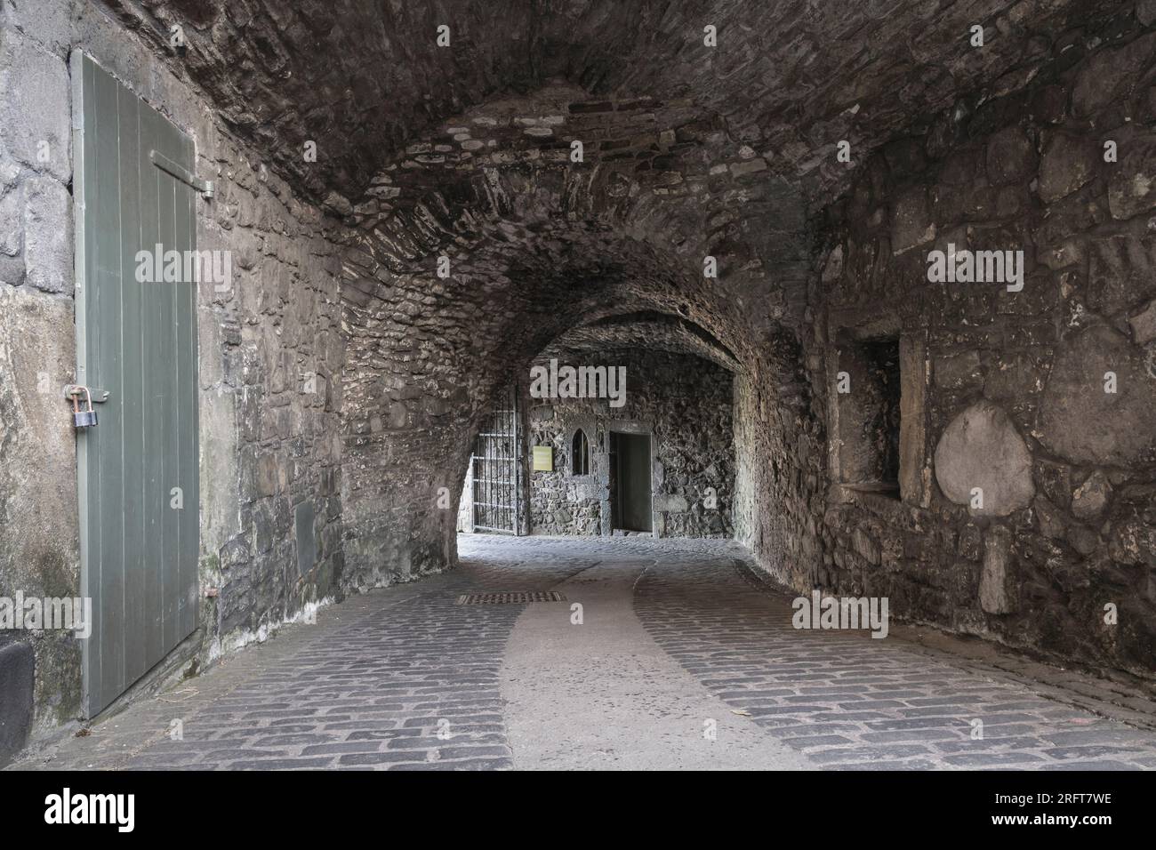 A visitor walking through the tunnel entrance to Chateau de Brancion &  historic village in Saone et Loire, Burgundy, France Stock Photo - Alamy