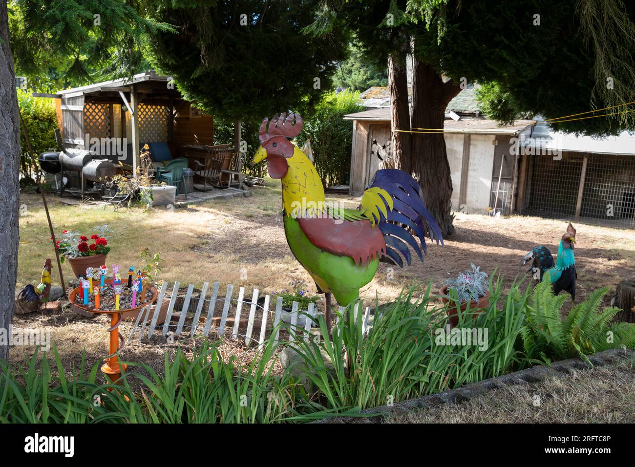 Rustic art fills a yard at a home in Seattle’s affluent North Admiral neighborhood. Stock Photo