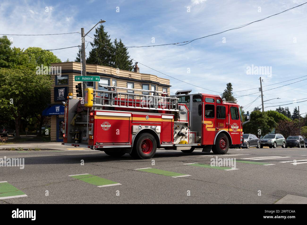 A fire engine from Fire Station 29 responds to an emergency along SW Admiral Way in Seattle’s affluent North Admiral neighborhood. Stock Photo