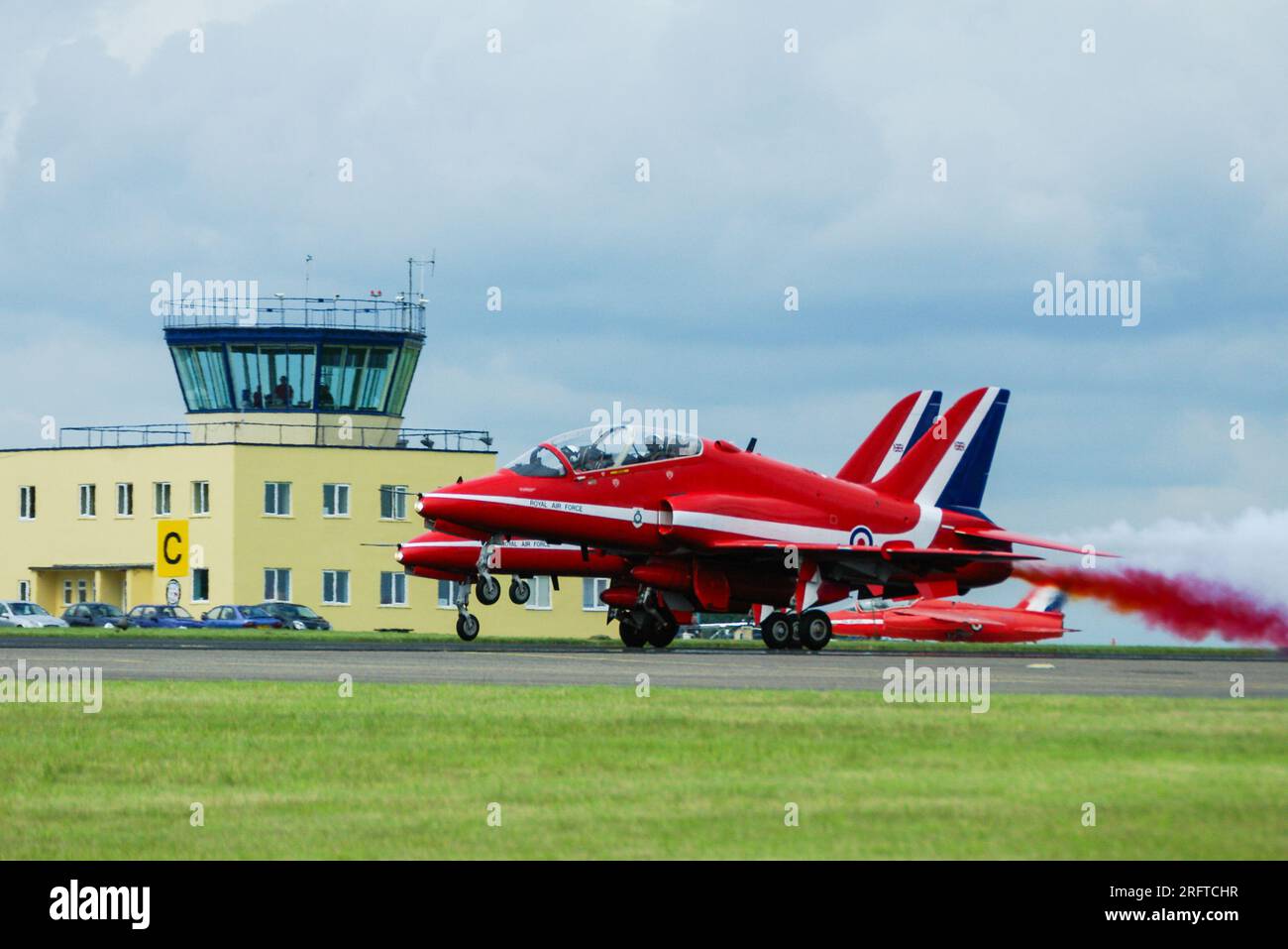 RAF Red Arrows BAe Hawk jet planes taking off at Cotswold Airport, formerly RAF Kemble, Gloucestershire, UK, where the team were based. Folland Gnat Stock Photo