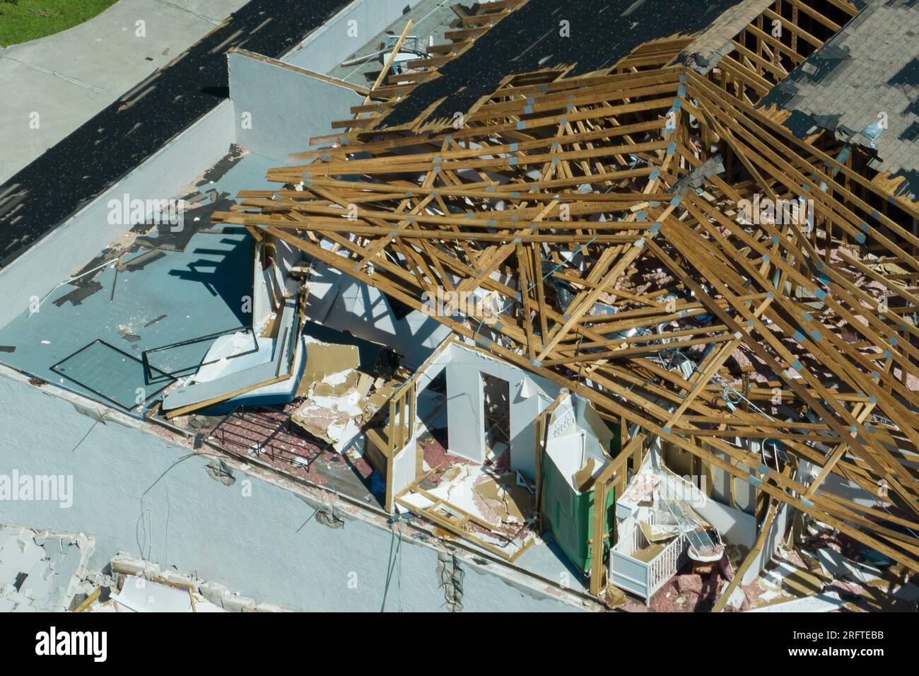 Damaged house roof and walls after hurricane Ian in Florida