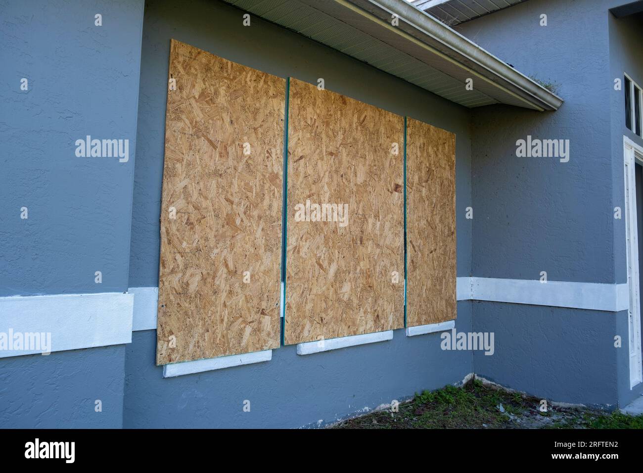 Hurricane shutters made from plywood mounted for protection of house