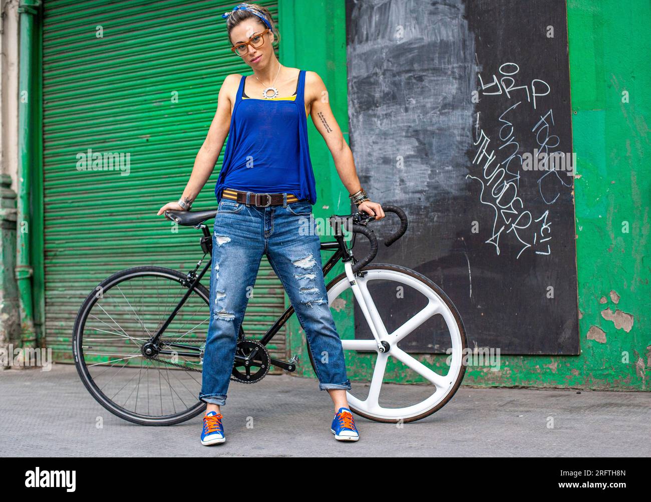 Young female with fixed gear bike , London , UK Stock Photo