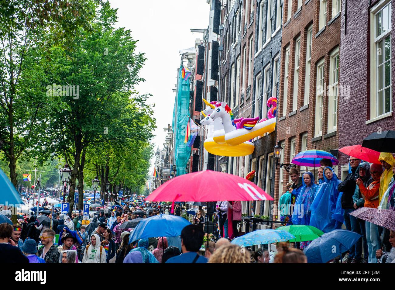 Three rainbow unicorns are seen hanging out from the windows during the event. The Canal Parade starts around noon and takes all afternoon. Around 80 boats of different organisations and non-profit organisations participate in the event. The Canal Parade is what Amsterdam Gay Pride is famous for. It's the crown of their two weeks lasting festival that features more than 200 events. The boats start at the Scheepvaart museum in the eastern part of the city center moving towards the Amstel River. (Photo by Ana Fernandez/SOPA Images/Sipa USA) Stock Photo