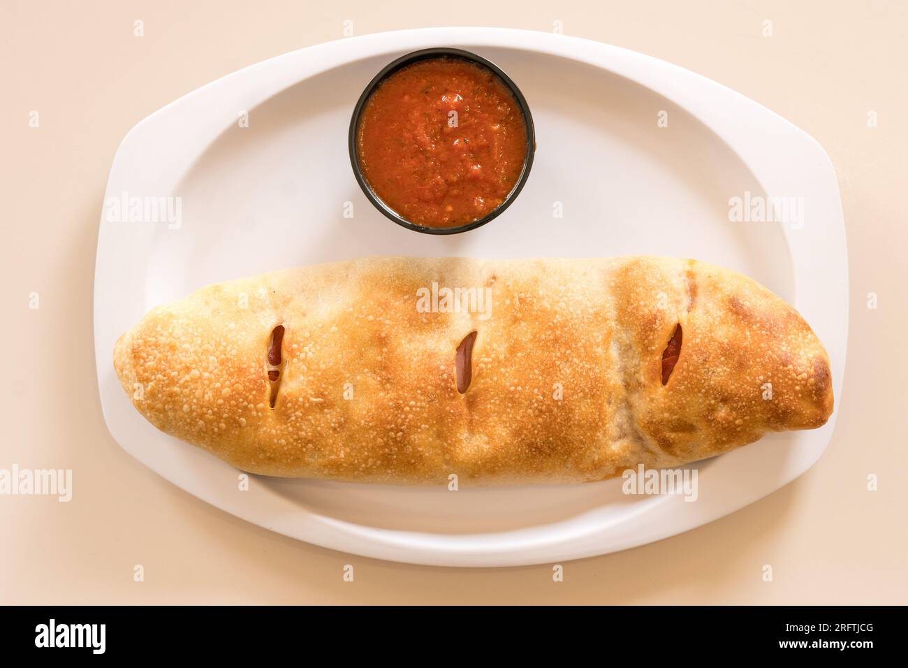 Stromboli with marinara sauce Stock Photo