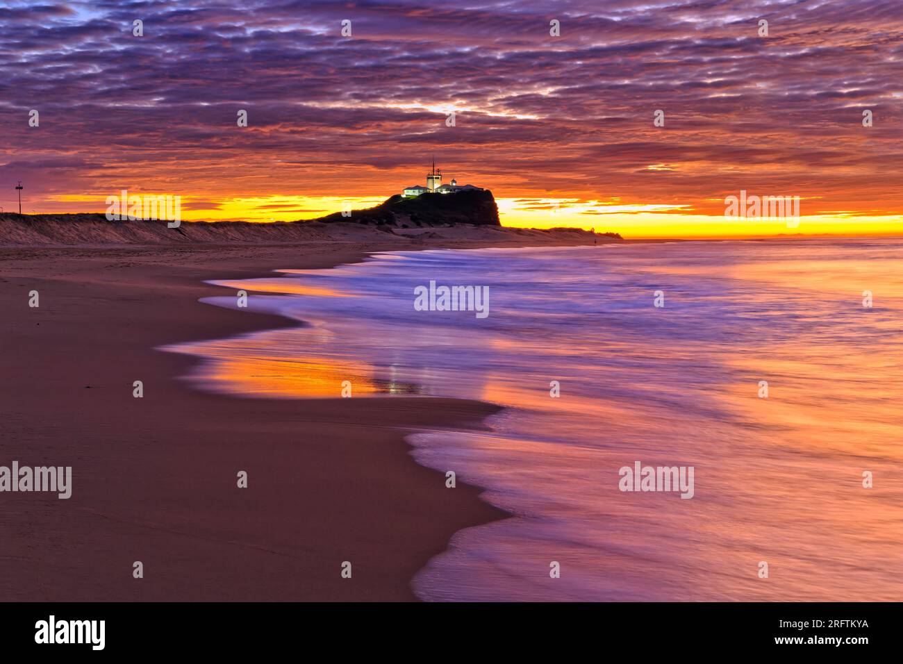 Nobbys head lighthouse on Nobbys beach in Newcastle of Australia at sunrise. Stock Photo