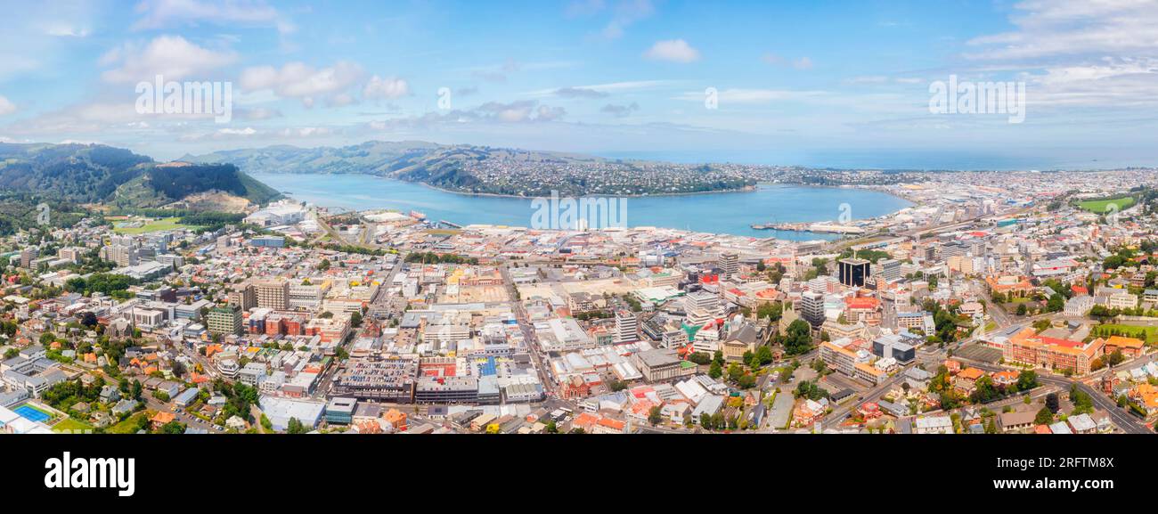 Dunedin city downtown on the South island of New Zealand - scenic wide aerial panorama over CBD. Stock Photo