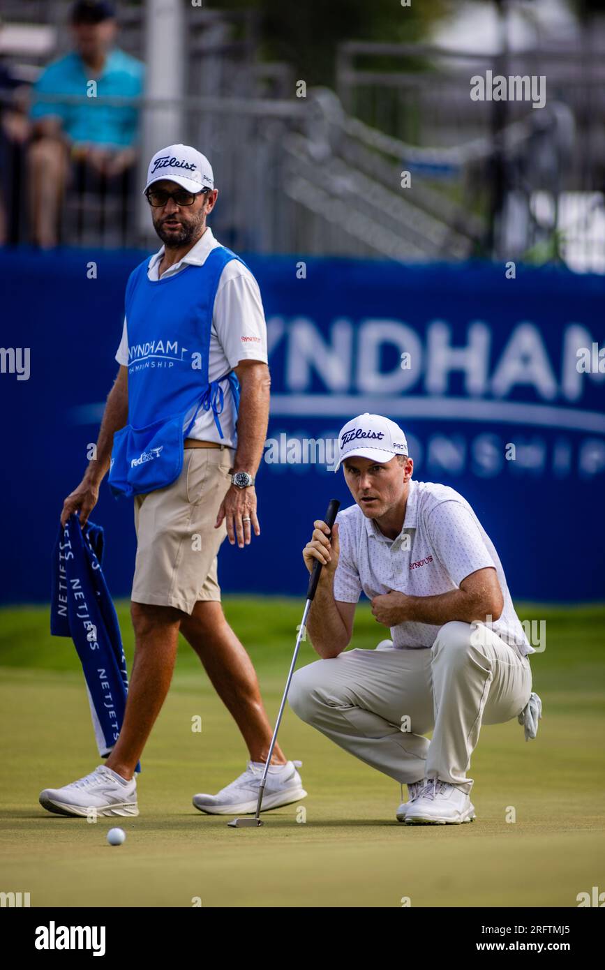August 5, 2023 Russell Henley and his caddie Andrew Sanders take a look at his birdie putt on