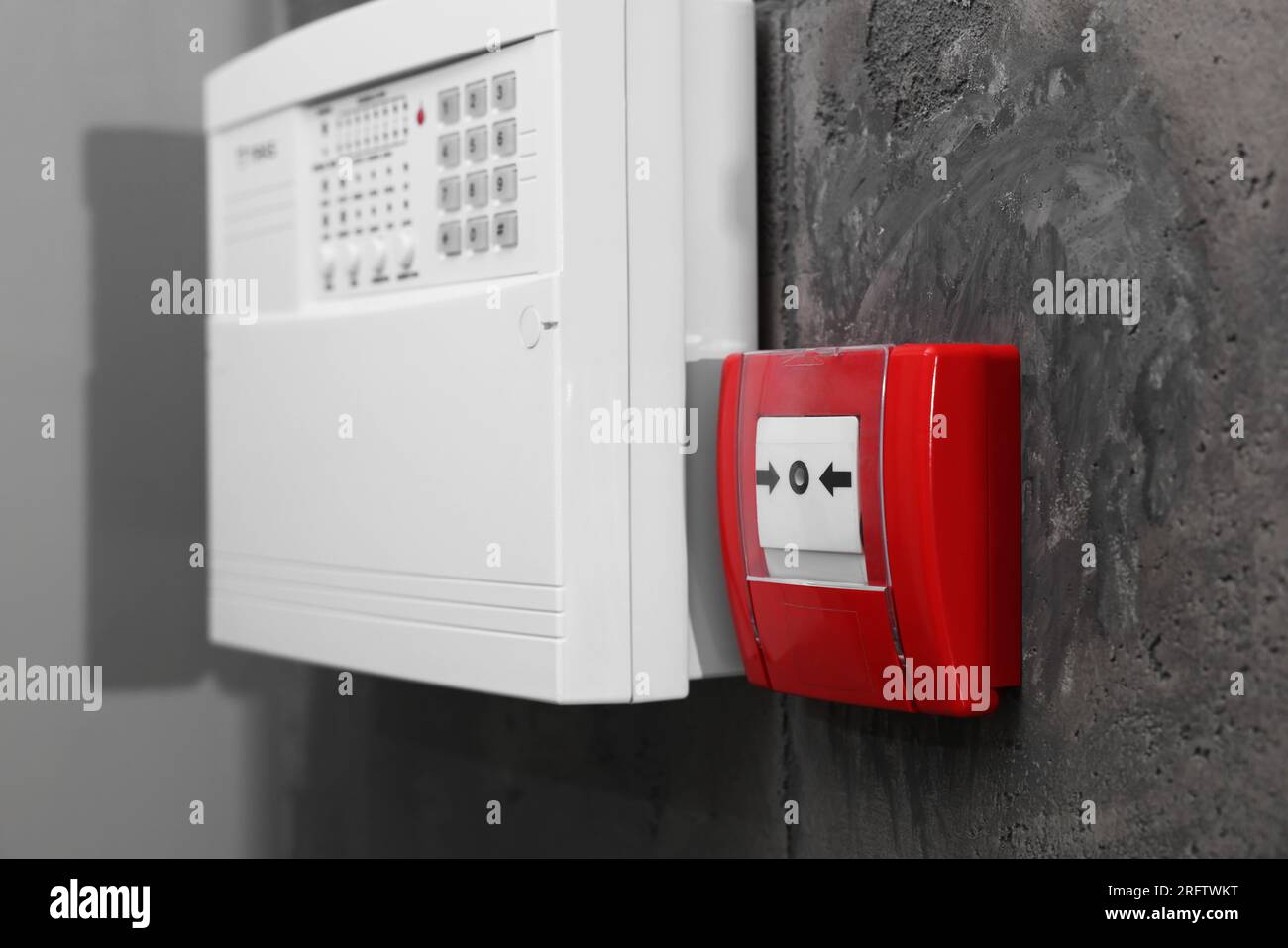 Fire alarm push button and house security system control panel on grey ...