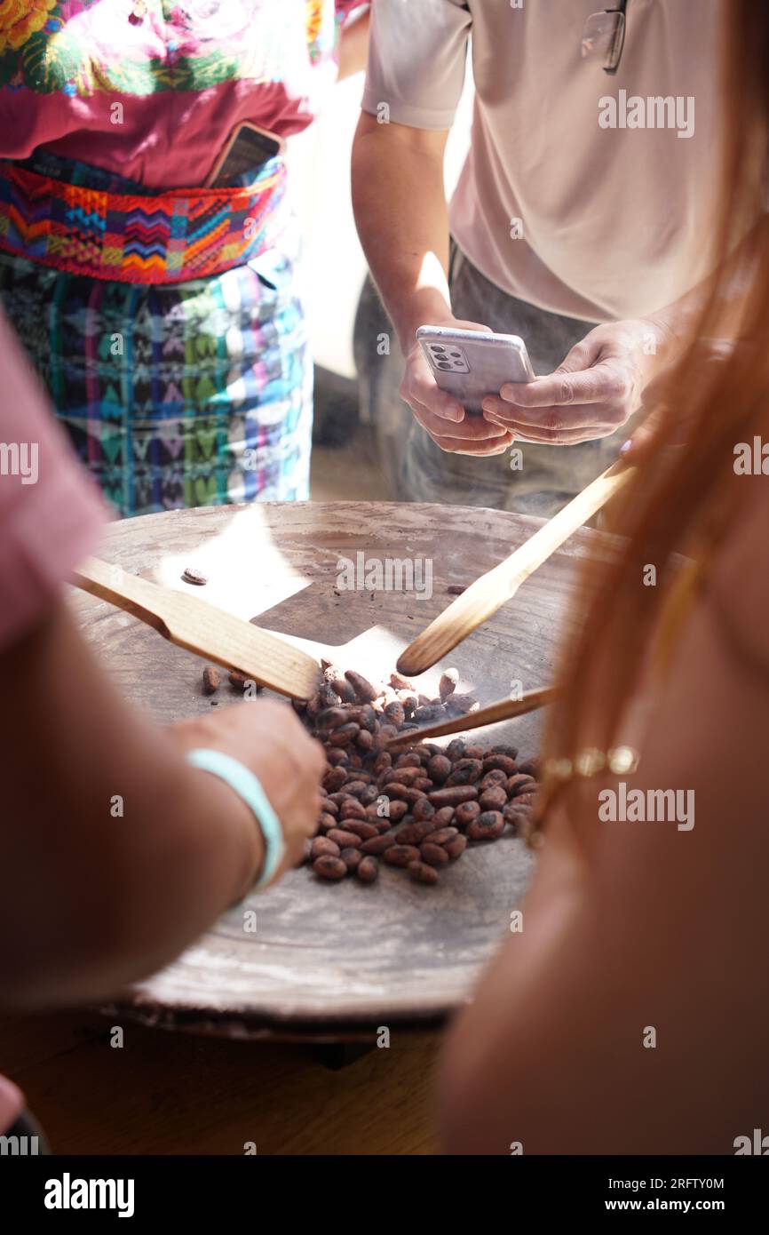 https://c8.alamy.com/comp/2RFTY0M/raw-cacao-beans-being-roasted-on-a-traditional-comal-clay-griddle-in-guatemala-for-chocolate-making-2RFTY0M.jpg