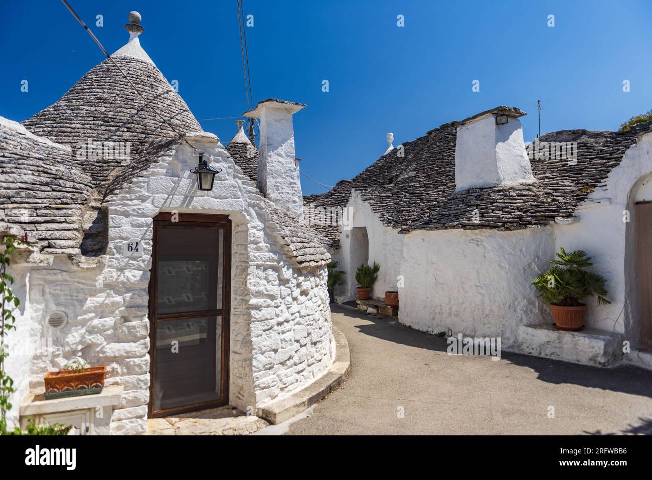 ITALY, PUGLIA, TRULLIS OF THE VILLAGE OF ALBEROBELLO, LISTED AS WORLD HERITAGE BY UNESCO. TRULLI ARE DRY-STONE DWELLINGS. THESE ARE REMARKABLE EXAMPLE Stock Photo