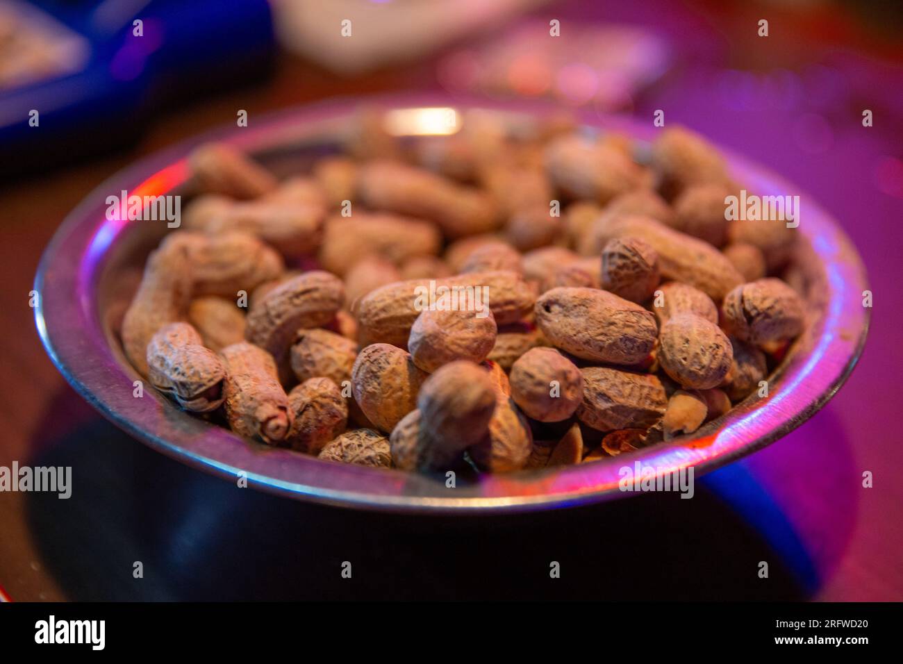 Bowl of peanuts on a bar top Stock Photo Alamy
