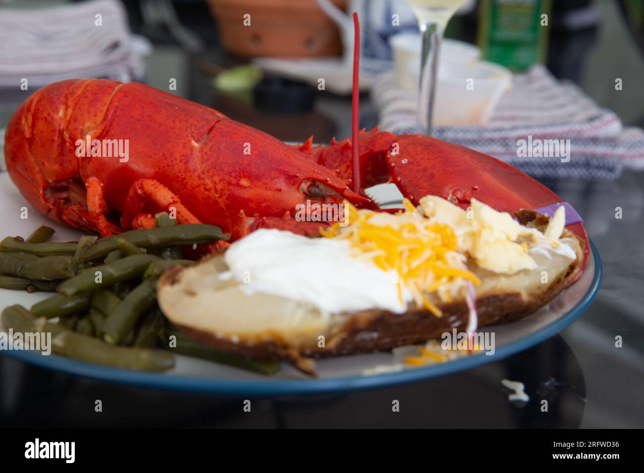 Maine lobster dinner with loaded baked potato Stock Photo Alamy