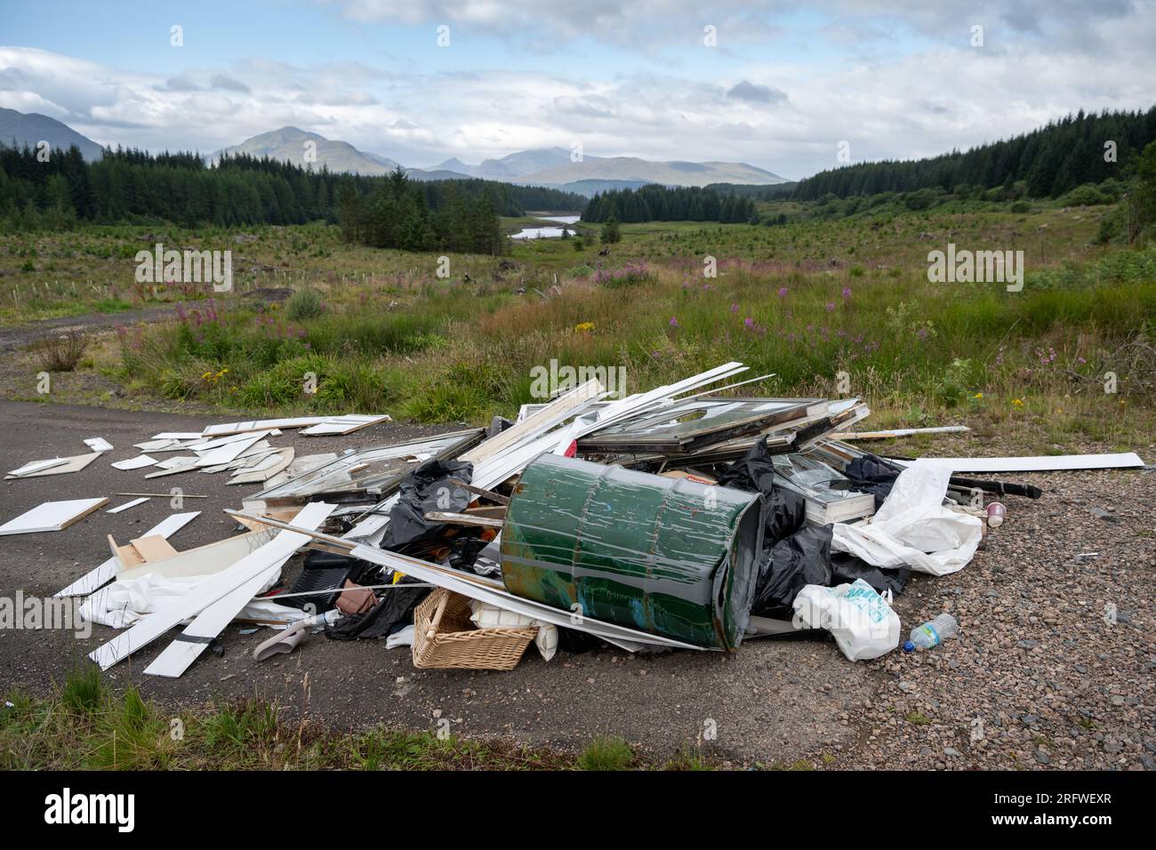 Builders waste fly tipped illegally in the Scottish Highlands, UK. Stock Photo