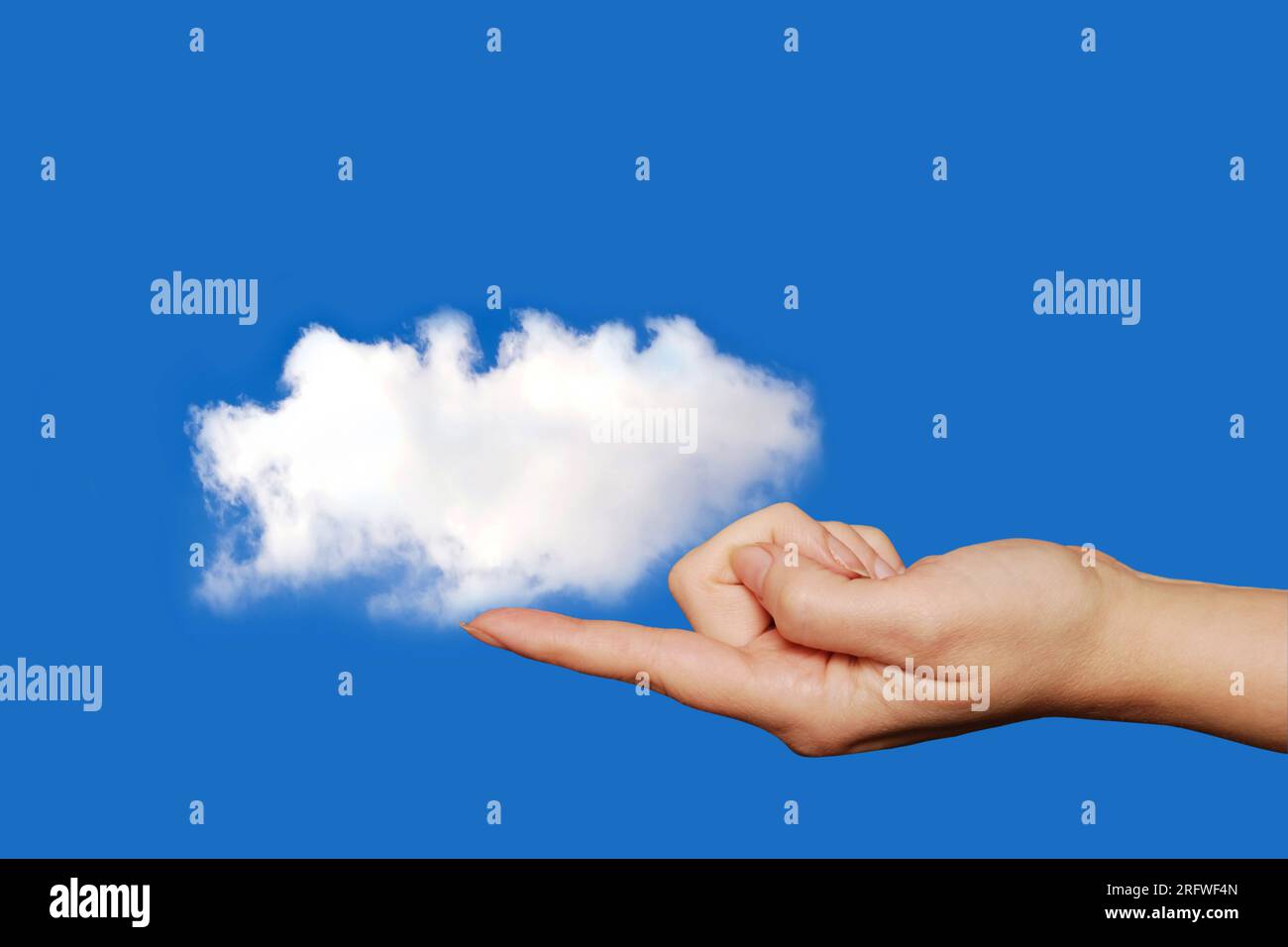 woman finger holding a white cloud, cloud computing concept Stock Photo