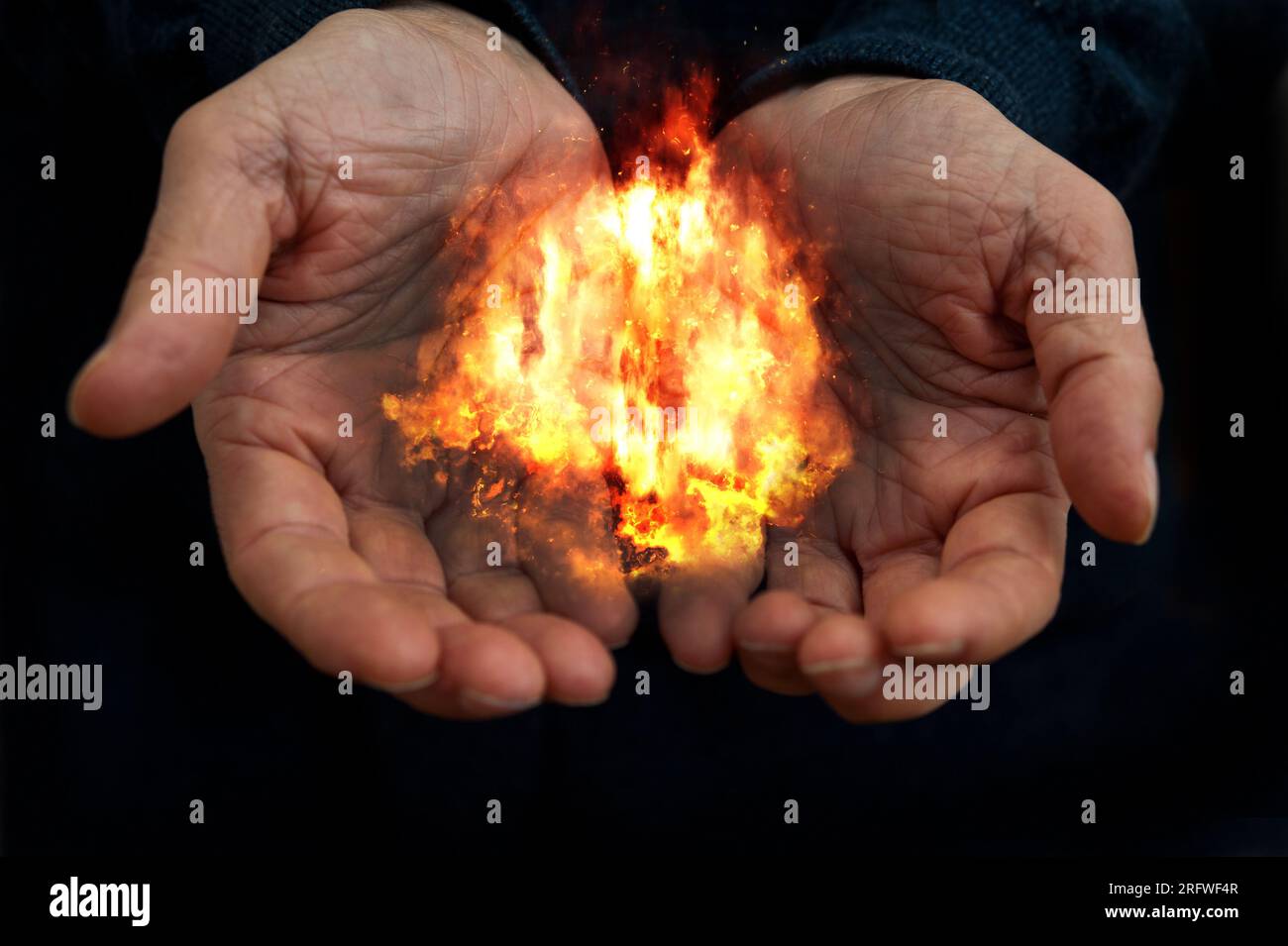 male open hands holding a fire Stock Photo