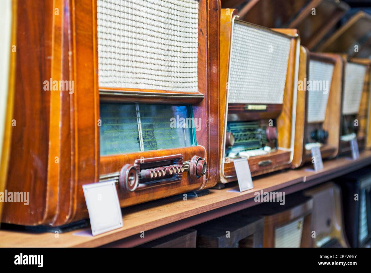 A lot of retro radios displayed over the shelves.  Stock Photo