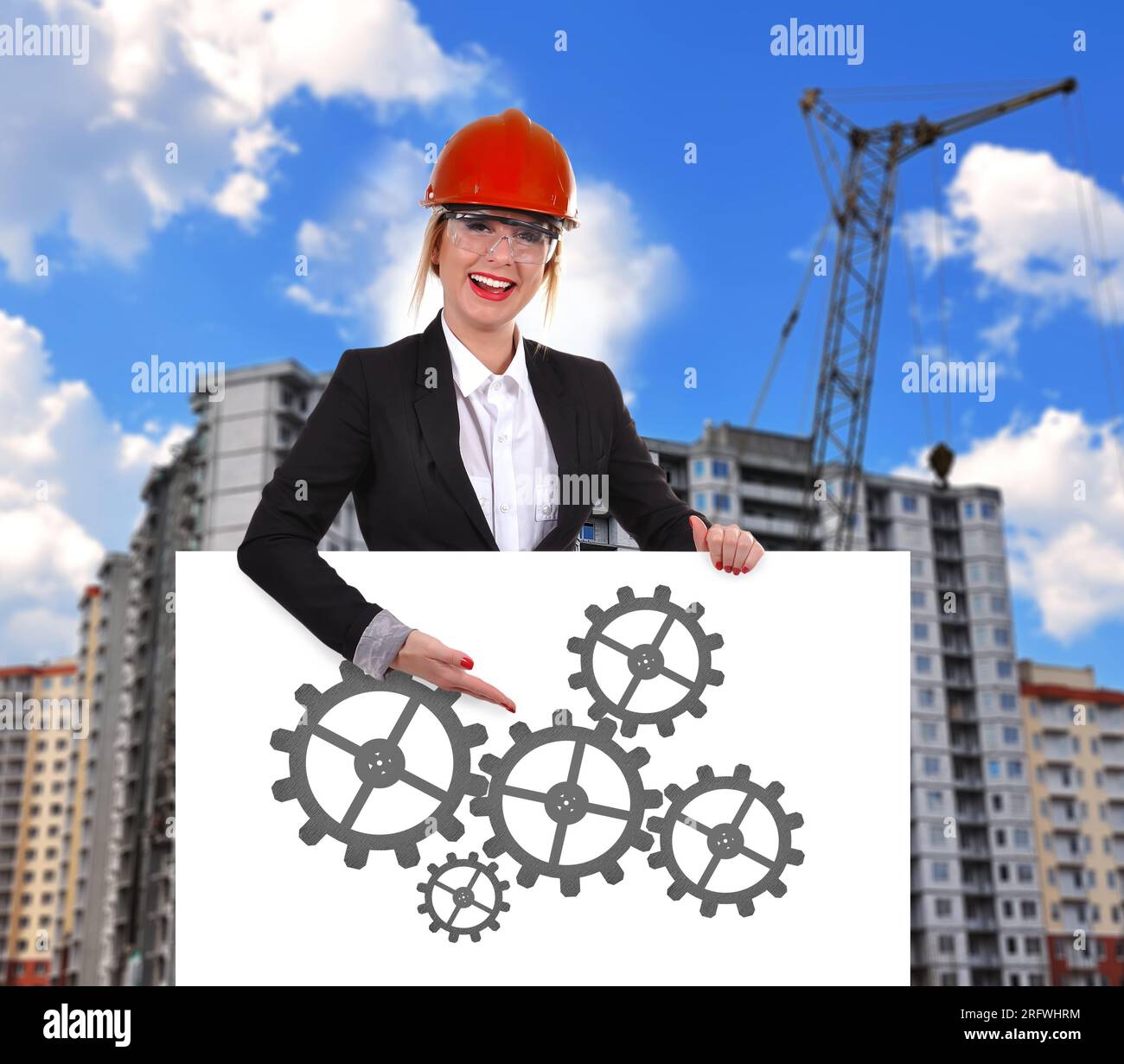 Engineer woman holding placard with cogs and wheels Stock Photo