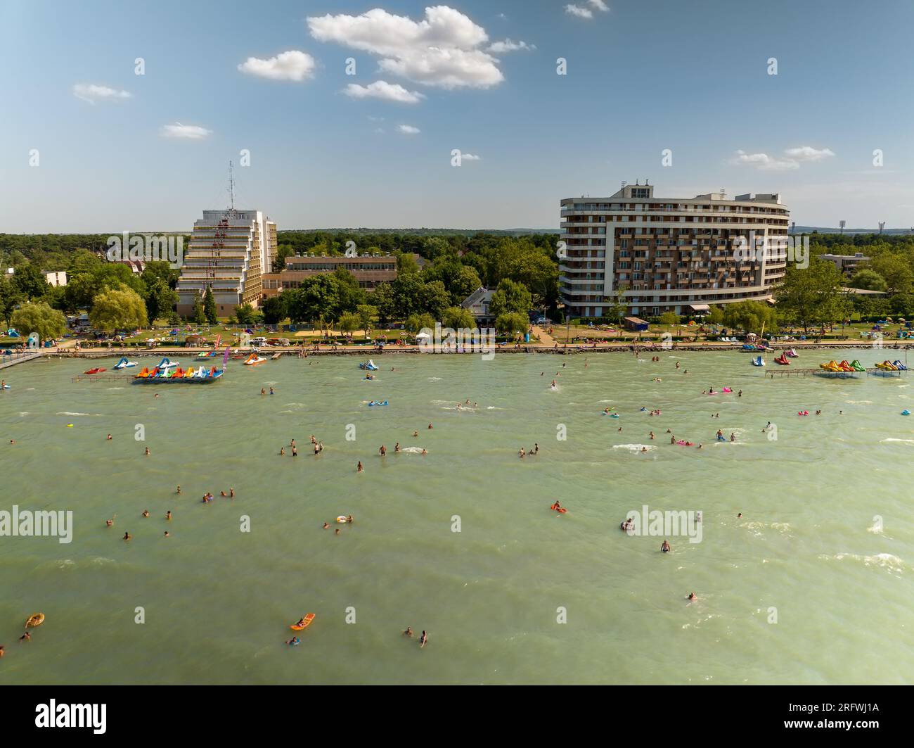 People bathing on lake Balaton at Gold coast of Siofok city. Lake Balaton is the Hungarian sea. Very popular tourist destination in this Country. Pano Stock Photo