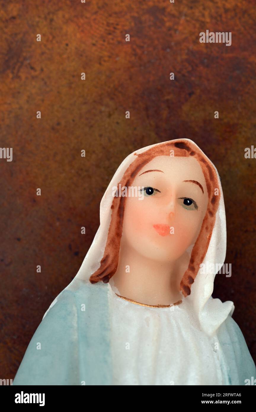 Model of head and shoulders of woman or nun with blue and white robe and head covering looking at viewer Stock Photo